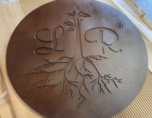 Cast iron plaque, baked-on-oil finish, with Lavish Roots catering logo