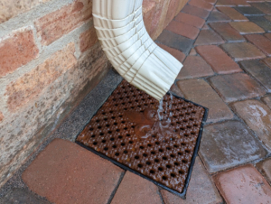 Cast iron drain grate with decorative fleur-de-lis pattern