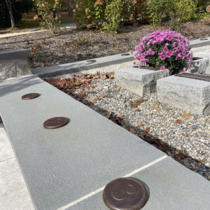 Raw cast iron medallions as memorial grid markers