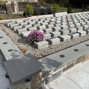 Raw cast iron medallions as memorial grid markers