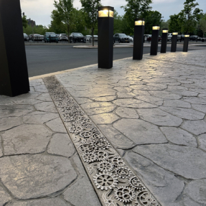 Raw Cast Aluminum solid trench grates in decorative Dynamo pattern that looks like interlocking gears from Iron Age Designs.