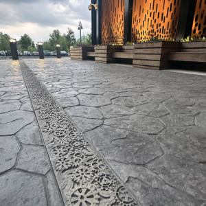 Raw Cast Aluminum solid trench grates in decorative Dynamo pattern that looks like interlocking gears from Iron Age Designs.