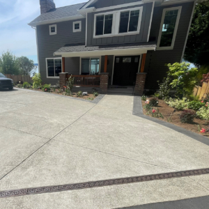 Raw cast iron trench grate in Greek Key pattern from Iron Age Designs. Installed in residential driveway.