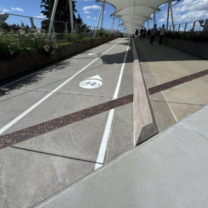 Raw cast iron trench grate in decorative Rain pattern from Iron Age Designs. Transit center installation.