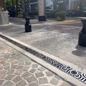 Cast iron trench grate in decorative Oblio pattern by Iron Age Designs. Streetscape installation.