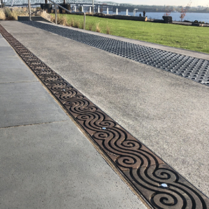 Cast iron trench grate in decorative Argo pattern by Iron Age Designs. Waterfront Park installation.