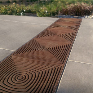 Cast iron grate in decorative Divisadero pattern by Iron Age Designs. Arrayed as bioswale inlet grates.