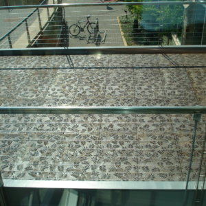 Cast iron grates in decorative Locust pattern by Iron Age Designs. Arrayed as a pedestrian bridge deck.