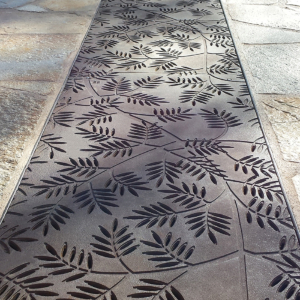 Cast iron grates in decorative Locust pattern by Iron Age Designs. Arrayed as a pedestrian bridge.