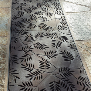 Cast iron grates in decorative Locust pattern by Iron Age Designs. Arrayed as a pedestrian bridge.