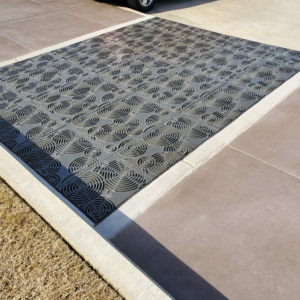 Cast iron grates in decorative Oblio pattern by Iron Age Designs. Arrayed as large stormwater inlet.