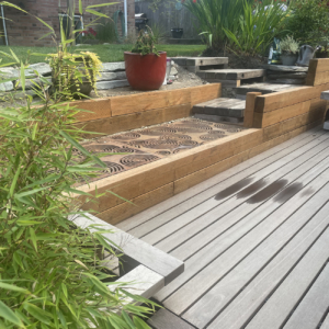 Cast iron grates in decorative Oblio pattern by Iron Age Designs. Arrayed as portion of backyard deck.