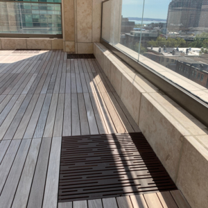 Cast iron grate in decorative Rain pattern by Iron Age Designs. Baked-on-oil finish. Rooftop deck installation.