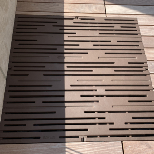 Cast iron grate in decorative Rain pattern by Iron Age Designs. Baked-on-oil finish. Rooftop deck installation.