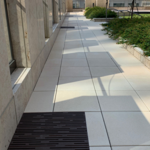 Cast iron grate in decorative Rain pattern by Iron Age Designs. Baked-on-oil finish. Rooftop deck installation.